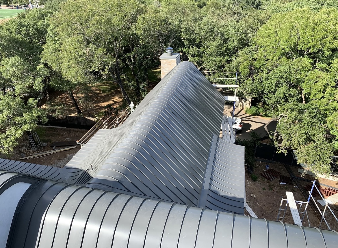 Curved standing-seam metal roof installed by Portillo Roofing