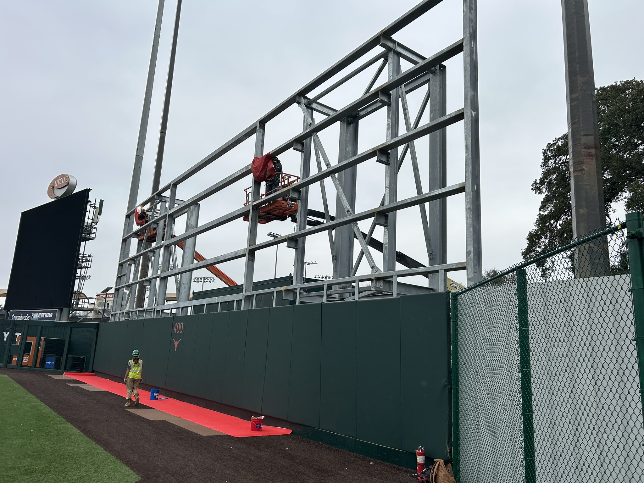 Portillo Roofing crew installing metal panels on the UT Austin batter's eye structure